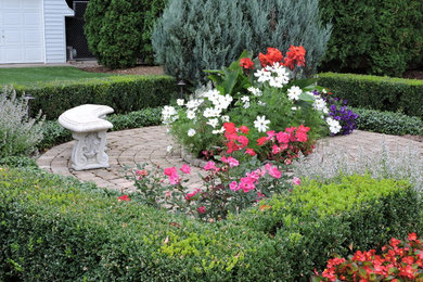 Inspiration for a small traditional partial sun backyard brick formal garden in Milwaukee for summer.