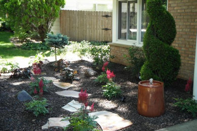 Design ideas for a medium sized front fully shaded garden in Grand Rapids with a garden path and natural stone paving.