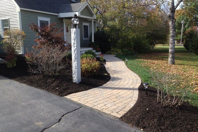 This is an example of a large partial sun front yard brick garden path in Portland Maine.