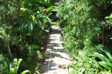 Photo of a transitional backyard brick garden path in Charleston.