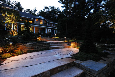 Design ideas for a large traditional partial sun front yard stone landscaping in Boston for summer.