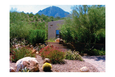 This is an example of a mid-sized traditional backyard concrete paver water fountain landscape in Phoenix.