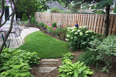 Idée de décoration pour un jardin arrière tradition de taille moyenne avec des pavés en béton.