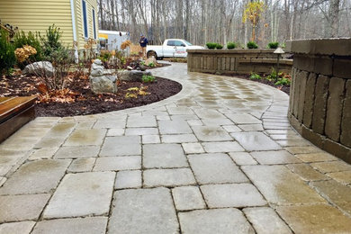 Photo of a mid-sized traditional partial sun front yard concrete paver walkway in New York for spring.
