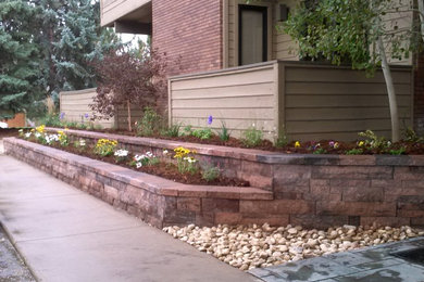 Photo of a side yard stone retaining wall landscape in Denver.