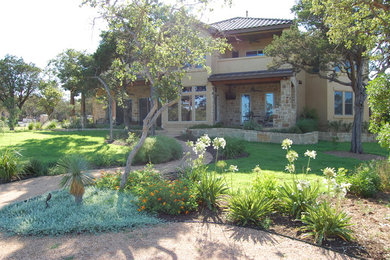 This is an example of a large rustic partial sun front yard gravel garden path in Austin.