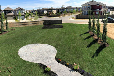 Photo of a huge modern full sun backyard landscaping in Edmonton.