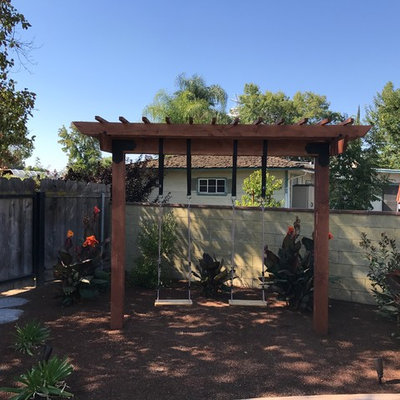 This is an example of a mid-sized shade backyard mulch formal garden in Other.
