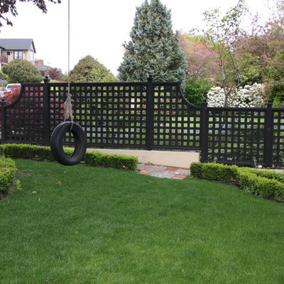 Inspiration for a large traditional full sun front yard stone landscaping in Seattle.