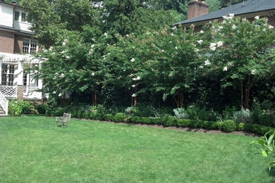 This is an example of a traditional partial sun backyard mulch formal garden in DC Metro.