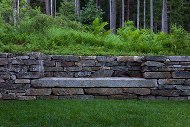 Rustic garden seating in Boston with a retaining wall.