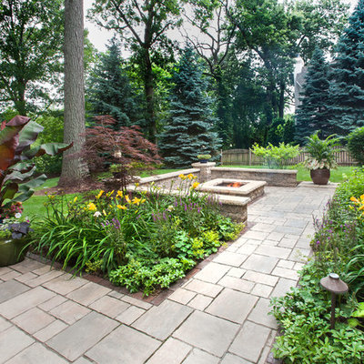Design ideas for a large traditional partial sun backyard brick driveway in Chicago with a fire pit for summer.