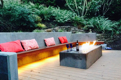 Leschi Modern  Backyard Sloped back concrete retaining wall serves double purpos