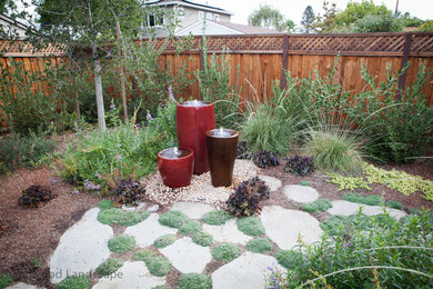 Design ideas for a large eclectic partial sun front yard stone formal garden in San Francisco.
