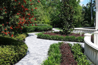 Design ideas for a mid-sized contemporary full sun side yard brick landscaping in Houston.
