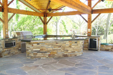 Inspiration for a timeless stone patio kitchen remodel in Austin
