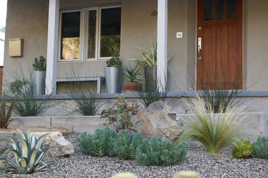 This is an example of a small modern drought-tolerant and full sun front yard gravel retaining wall landscape in Los Angeles.