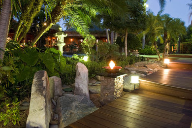 This is an example of an asian landscaping in Miami with a fire pit.