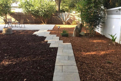 Design ideas for a large modern drought-tolerant and partial sun backyard concrete paver garden path in Sacramento for spring.