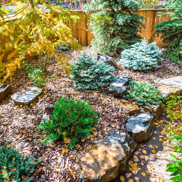 Low Maintenance Side Yard with Bark Nuggets & Rock Retaining Wall