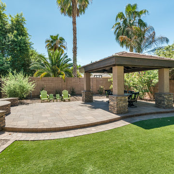 Lush Landscape with Artificial Turf, Stone Fireplace, Cabana, and Paver Patio