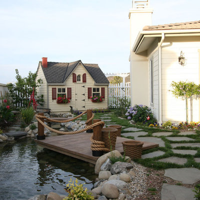 This is an example of a mid-sized traditional partial sun backyard stone landscaping in Los Angeles.