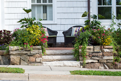 This is an example of a traditional full sun brick retaining wall landscape in Minneapolis.