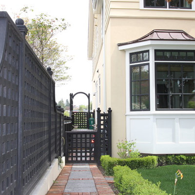 This is an example of a large traditional full sun front yard stone landscaping in Seattle.