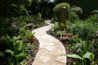 Inspiration for a partial sun backyard stone garden path in Jacksonville.