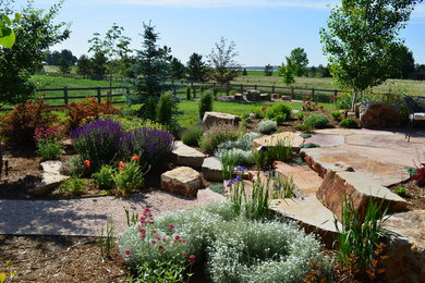 Design ideas for a large classic back full sun garden in Other with a garden path and natural stone paving.