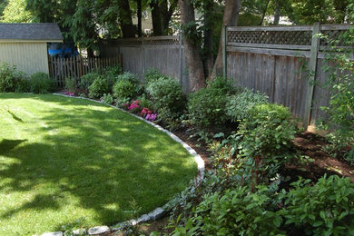 Photo of a mid-sized eclectic drought-tolerant and partial sun backyard stone landscaping in Boston for summer.