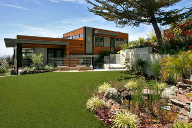 Inspiration for a large modern back xeriscape full sun garden in San Francisco with a water feature and natural stone paving.