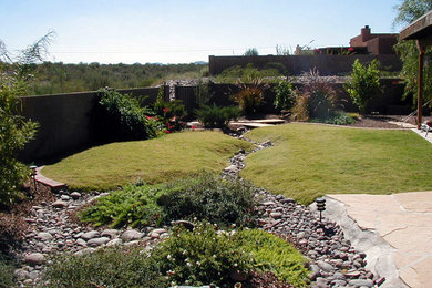 Inspiration for a mid-sized southwestern full sun backyard stone landscaping in Phoenix.