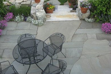 Inspiration for a small eclectic partial sun backyard stone landscaping in Boston for summer.