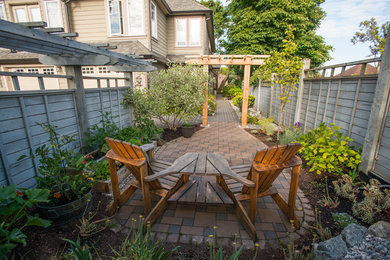 Photo of a small asian full sun side yard brick formal garden in Vancouver for summer.