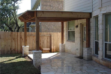 Design ideas for a backyard stone landscaping in Austin.