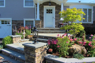 Design ideas for a mid-sized traditional front yard concrete paver retaining wall landscape in New York.