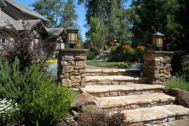 Photo of a large traditional full sun front yard concrete paver landscaping in Sacramento.