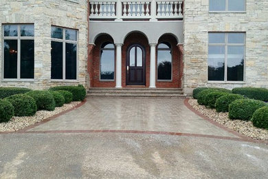 Photo of a large traditional partial sun front yard gravel driveway in Other.