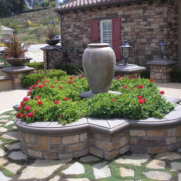 Mediterranean fountain with dymondia between stepping stones.