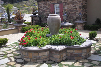 Photo of a large mediterranean full sun courtyard stone landscaping in Los Angeles for spring.