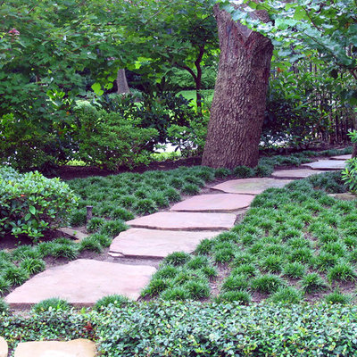 Photo of a mediterranean backyard stone landscaping in Houston.