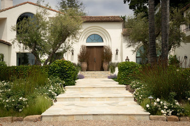 Design ideas for a mediterranean full sun front yard stone formal garden in Santa Barbara.
