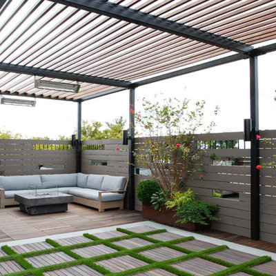 This is an example of a contemporary backyard landscaping in New York with a fire pit and decking.