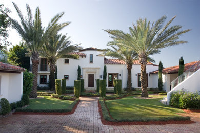 Design ideas for a large mediterranean partial sun front yard brick driveway in Miami for spring.