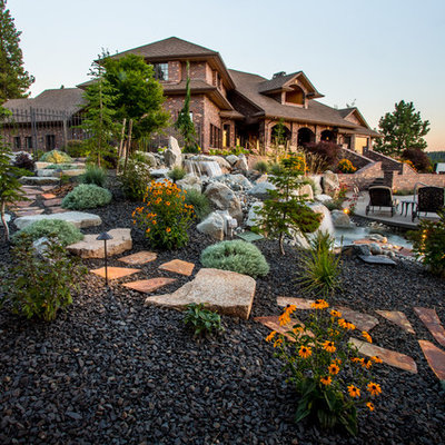 This is an example of a large traditional backyard gravel landscaping in Seattle.