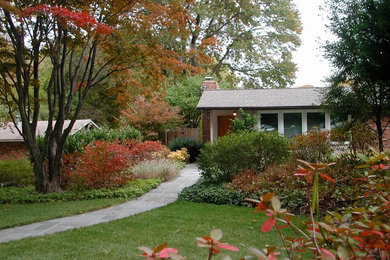 Design ideas for a mid-sized mid-century modern full sun front yard stone garden path in DC Metro for fall.