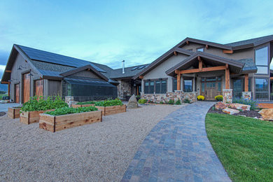 Photo of a mid-sized rustic partial sun front yard gravel landscaping in Salt Lake City for summer.