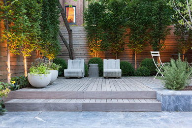 This is an example of a medium sized contemporary back partial sun garden for winter in New York with an outdoor sport court and natural stone paving.