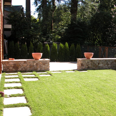 This is an example of a mid-sized traditional full sun backyard stone water fountain landscape in San Francisco.